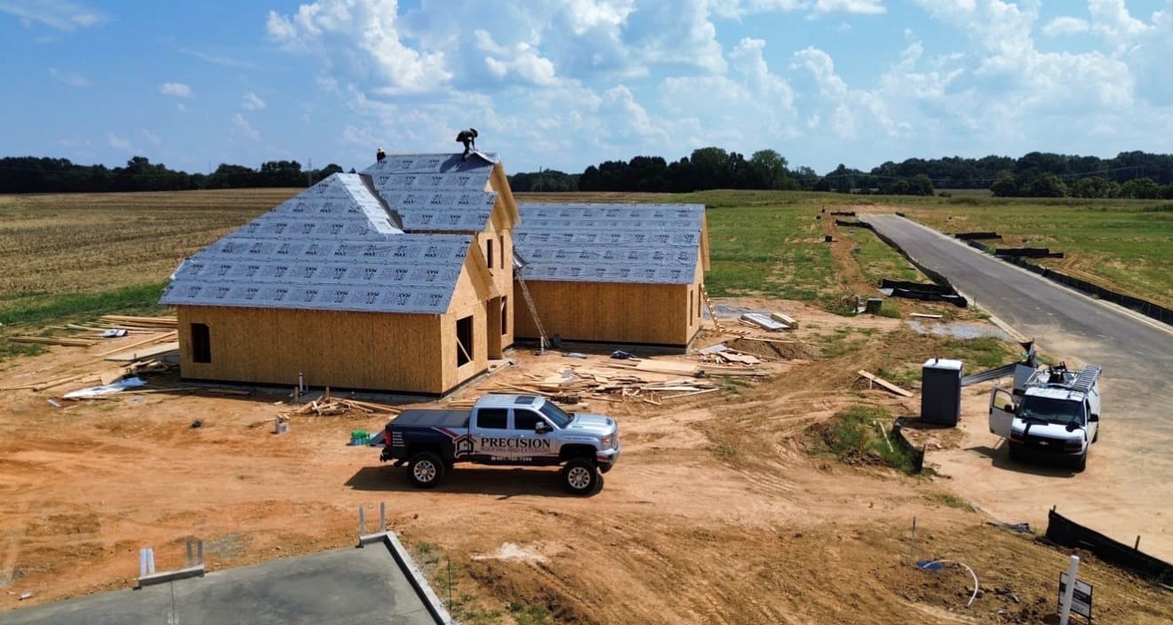 New roof dried in by Precision Roofing and Exteriors with the company truck on site in the Memphis area