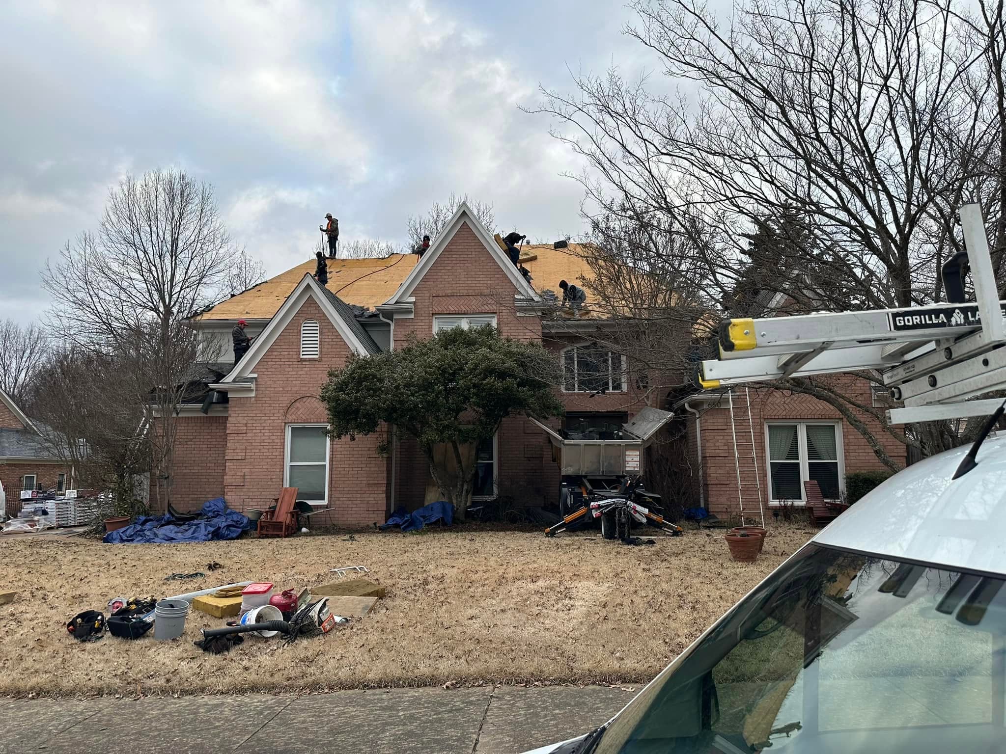 Precision Roofing and Exteriors crew re-decking a large brick home in the Memphis area